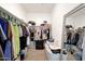Walk-in closet with shelving, hanging rods, and a full-length mirror at 30777 W Whitton Ave, Buckeye, AZ 85396