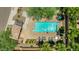 Aerial view of a community pool with patio furniture, ramada, desert landscaping, and neighborhood at 322 N 78Th Pl, Mesa, AZ 85207