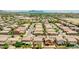 An aerial shot of a well-maintained neighborhood with lush landscaping and stunning mountain views at 322 N 78Th Pl, Mesa, AZ 85207
