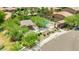 Aerial view of a community pool area with desert landscaping, ramada, and lounge chairs around a gated pool at 322 N 78Th Pl, Mesa, AZ 85207