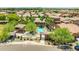 Aerial view of community pool area with ramada, desert landscaping, and nearby neighborhood streets at 322 N 78Th Pl, Mesa, AZ 85207