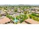 Wide aerial shot of desert neighborhood with homes, palm trees, mature trees, and mountain views in the background at 322 N 78Th Pl, Mesa, AZ 85207