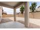 Covered back patio with concrete columns overlooking a spacious backyard at 322 N 78Th Pl, Mesa, AZ 85207