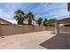 An enclosed backyard space features a block fence and palm trees at 322 N 78Th Pl, Mesa, AZ 85207