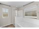Bright bathroom featuring a separate shower and tub with natural light from windows at 322 N 78Th Pl, Mesa, AZ 85207