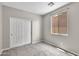 Cozy bedroom featuring neutral walls, plush carpet, and a window for natural light at 322 N 78Th Pl, Mesa, AZ 85207