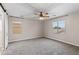 Spacious bedroom with plush carpeting, ceiling fan, and abundant natural light at 322 N 78Th Pl, Mesa, AZ 85207