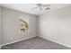 A simple bedroom features neutral walls, carpet, and a ceiling fan at 322 N 78Th Pl, Mesa, AZ 85207