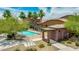 Community pool surrounded by tropical landscaping and lawn chairs, with ramada, desert shrubs, and mature trees at 322 N 78Th Pl, Mesa, AZ 85207