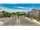 Community entrance featuring iron gates, landscaping, and well-maintained grounds at 322 N 78Th Pl, Mesa, AZ 85207