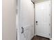 Hallway featuring a barn-style sliding door, dark wood floors and a white front door at 322 N 78Th Pl, Mesa, AZ 85207