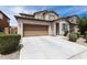 A bright shot of this house shows its large driveway, its two car garage, and trimmed green foliage at 322 N 78Th Pl, Mesa, AZ 85207