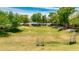 Large grassy community field with mature landscaping, desert trees and shrubs, and seating throughout at 322 N 78Th Pl, Mesa, AZ 85207