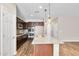 Modern kitchen with stainless appliances, granite counters, and wood-look floors at 322 N 78Th Pl, Mesa, AZ 85207