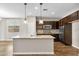 Well-lit kitchen showcasing a center island with granite countertops, and modern cabinetry at 322 N 78Th Pl, Mesa, AZ 85207