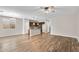Open-concept living room featuring wood-look floors, kitchen with island, and abundant natural light at 322 N 78Th Pl, Mesa, AZ 85207