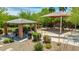 Community playground with picnic tables, shade, a grill, and modern climbing equipment on a gravel lot at 322 N 78Th Pl, Mesa, AZ 85207