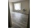 Spacious bedroom with neutral walls, contemporary vinyl flooring, and a sun-drenched window at 3229 W Cholla St, Phoenix, AZ 85029