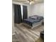 Spacious bedroom with wood-look floors and large window at 3229 W Cholla St, Phoenix, AZ 85029