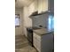 Kitchen featuring stainless range, granite countertops, white cabinets, vinyl floors, and an open serving area at 3229 W Cholla St, Phoenix, AZ 85029