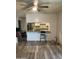 Spacious living room with vinyl flooring, view into updated kitchen, and contemporary ceiling fan at 3229 W Cholla St, Phoenix, AZ 85029