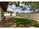 View of backyard with grassy area, storage shed, block fence, and covered patio at 3719 W Griswold Rd, Phoenix, AZ 85051