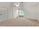 Bright bedroom with large sliding glass doors to back yard, neutral carpet and attached closet at 3719 W Griswold Rd, Phoenix, AZ 85051