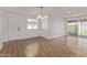 Dining room with tile flooring, a modern chandelier, and a sliding glass door at 3719 W Griswold Rd, Phoenix, AZ 85051