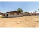 A neutral colored single-story home featuring a spacious front yard and a covered porch at 3719 W Griswold Rd, Phoenix, AZ 85051