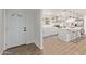 Bright kitchen with a center island, modern appliances, and wooden tile floors at 3719 W Griswold Rd, Phoenix, AZ 85051