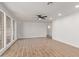 Bright and airy living room featuring wooden tile floors and large windows at 3719 W Griswold Rd, Phoenix, AZ 85051