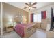 Comfortable bedroom with a ceiling fan, a queen bed and natural light at 3830 E Lakewood Pkwy # 1057, Phoenix, AZ 85048