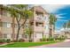 Exterior view of the building featuring multiple units, balconies, and well-kept landscaping at 3830 E Lakewood Pkwy # 1057, Phoenix, AZ 85048