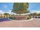 The entrance to the Portofino community is brick-paved with lush landscaping and a mature shade tree at 3830 E Lakewood Pkwy # 1057, Phoenix, AZ 85048