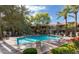Inviting community pool with lounge chairs, mature landscaping, and ample space for relaxation at 3830 E Lakewood Pkwy # 1057, Phoenix, AZ 85048