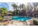 Resort-style community pool area with palm trees and lounge chairs for relaxing and soaking up the sun at 3830 E Lakewood Pkwy # 1057, Phoenix, AZ 85048