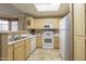 Functional kitchen with ample counter space, white appliances, and plenty of storage in the cabinetry at 3830 E Lakewood Pkwy # 1057, Phoenix, AZ 85048