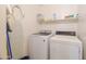 Bright laundry room featuring a full size washer, dryer and shelving at 3830 E Lakewood Pkwy # 1057, Phoenix, AZ 85048