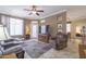 Cozy living room featuring comfortable seating, a ceiling fan, and great natural light from large windows at 3830 E Lakewood Pkwy # 1057, Phoenix, AZ 85048