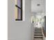 Hallway with decorative window, stairs leading up to a bright, neutral living space at 3935 E Rough Rider Rd # 1039, Phoenix, AZ 85050