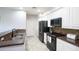 Well-lit kitchen with black appliances, granite countertops, white cabinets, and a stainless steel sink at 3935 E Rough Rider Rd # 1039, Phoenix, AZ 85050