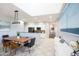 Open kitchen and dining room with a wooden dining table, modern light fixtures, and stylish decor at 3935 E Rough Rider Rd # 1039, Phoenix, AZ 85050
