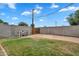 Fenced backyard with block wall, grass, and access gate at 4102 W Golden Ln, Phoenix, AZ 85051