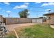 Spacious backyard with block fence, a mix of green grass and brick, and an equipment shed at 4102 W Golden Ln, Phoenix, AZ 85051