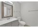 Bathroom with light gray vanity, large mirror, and tiled shower at 4102 W Golden Ln, Phoenix, AZ 85051