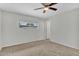 Neutral bedroom with carpet, ceiling fan, and a window providing outside view at 4102 W Golden Ln, Phoenix, AZ 85051