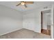 Bedroom with neutral carpet, ceiling fan, and closet with folding doors at 4102 W Golden Ln, Phoenix, AZ 85051