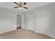 Carpeted bedroom features a ceiling fan and closet at 4102 W Golden Ln, Phoenix, AZ 85051