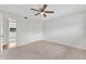Spacious bedroom featuring neutral carpet, ceiling fan, and closet with folding doors at 4102 W Golden Ln, Phoenix, AZ 85051