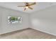 Carpeted bedroom featuring a ceiling fan and a window at 4102 W Golden Ln, Phoenix, AZ 85051